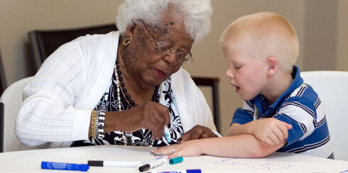 Woman with child using markers